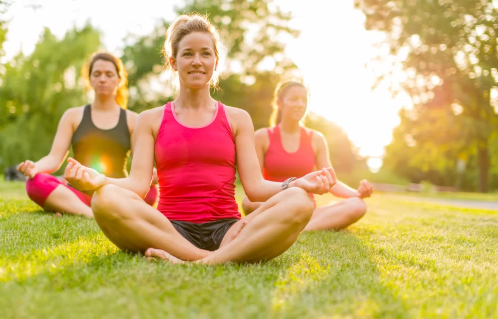 Women doing Yoga in Park