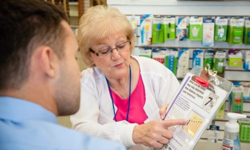 Pharmacist educating patient about diabetes care